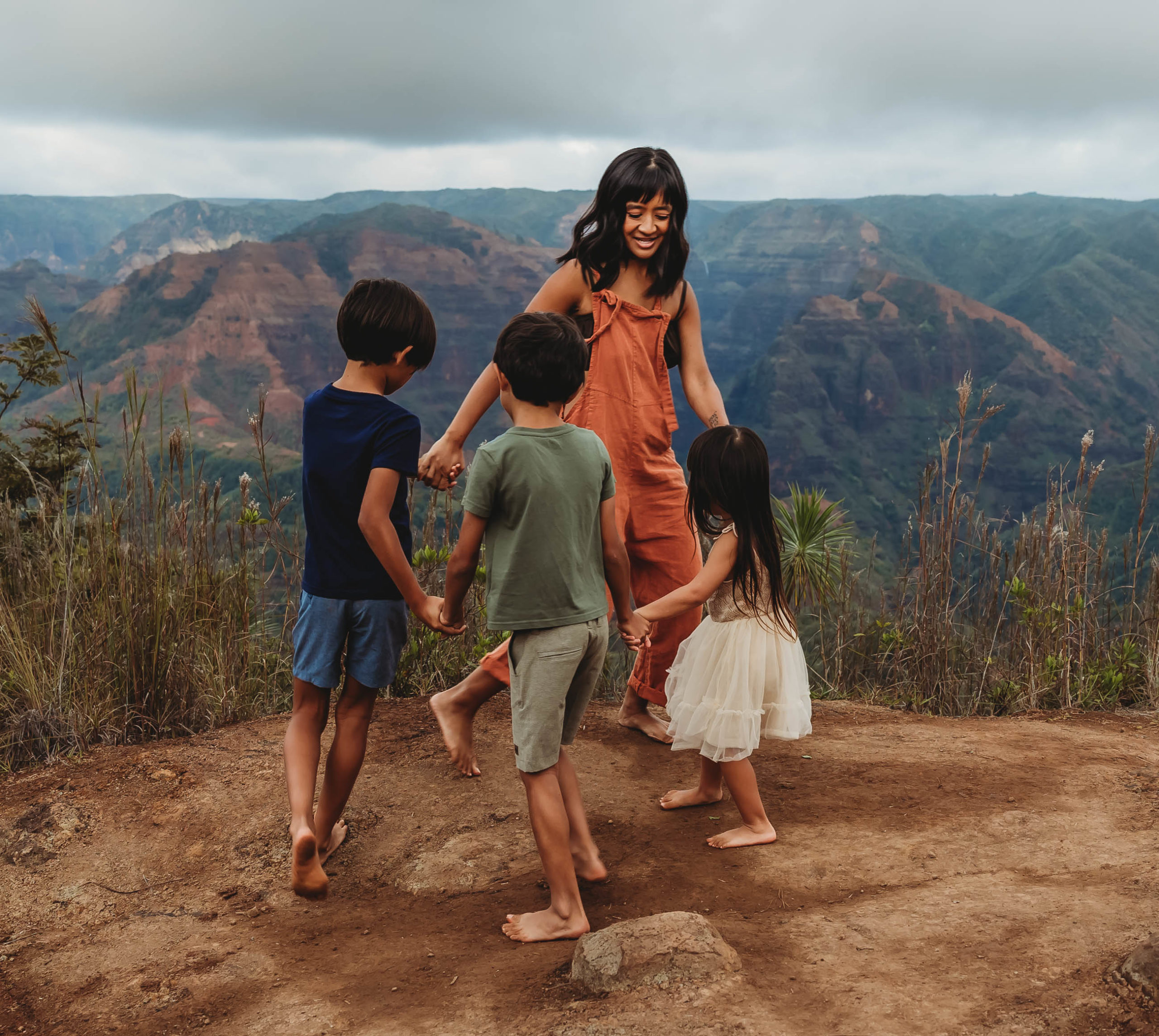 Family of six smiling at Waimea Canyon in Kauai

