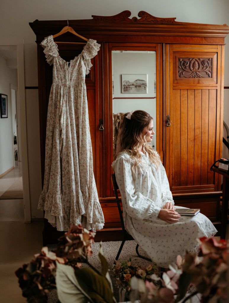 bride looking out window – getting ready wedding photos in Iceland