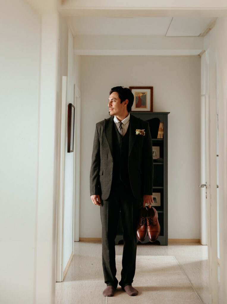 groom portraits – getting ready wedding photos in hallway in Iceland