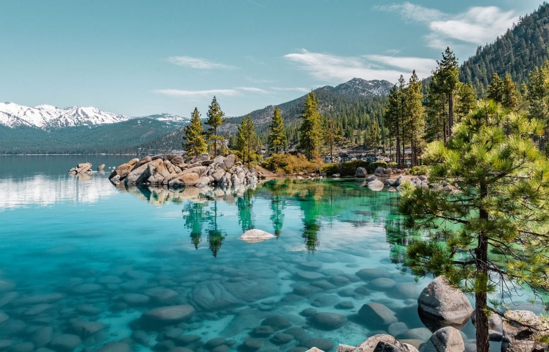 Lake Tahoe shoreline with blue water and mountain peaks – unique places to elope in Nevada