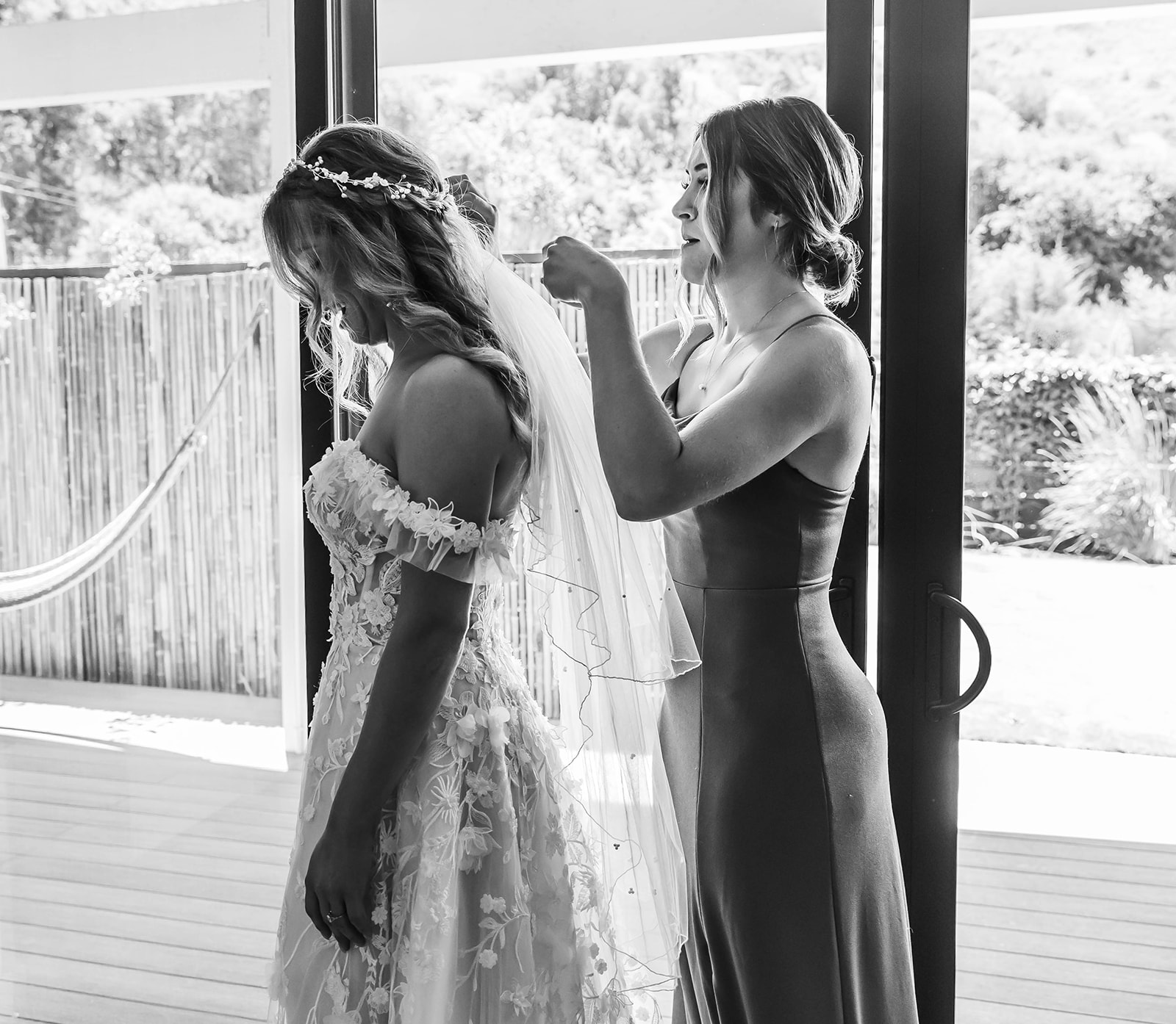 Sister helping put on veil