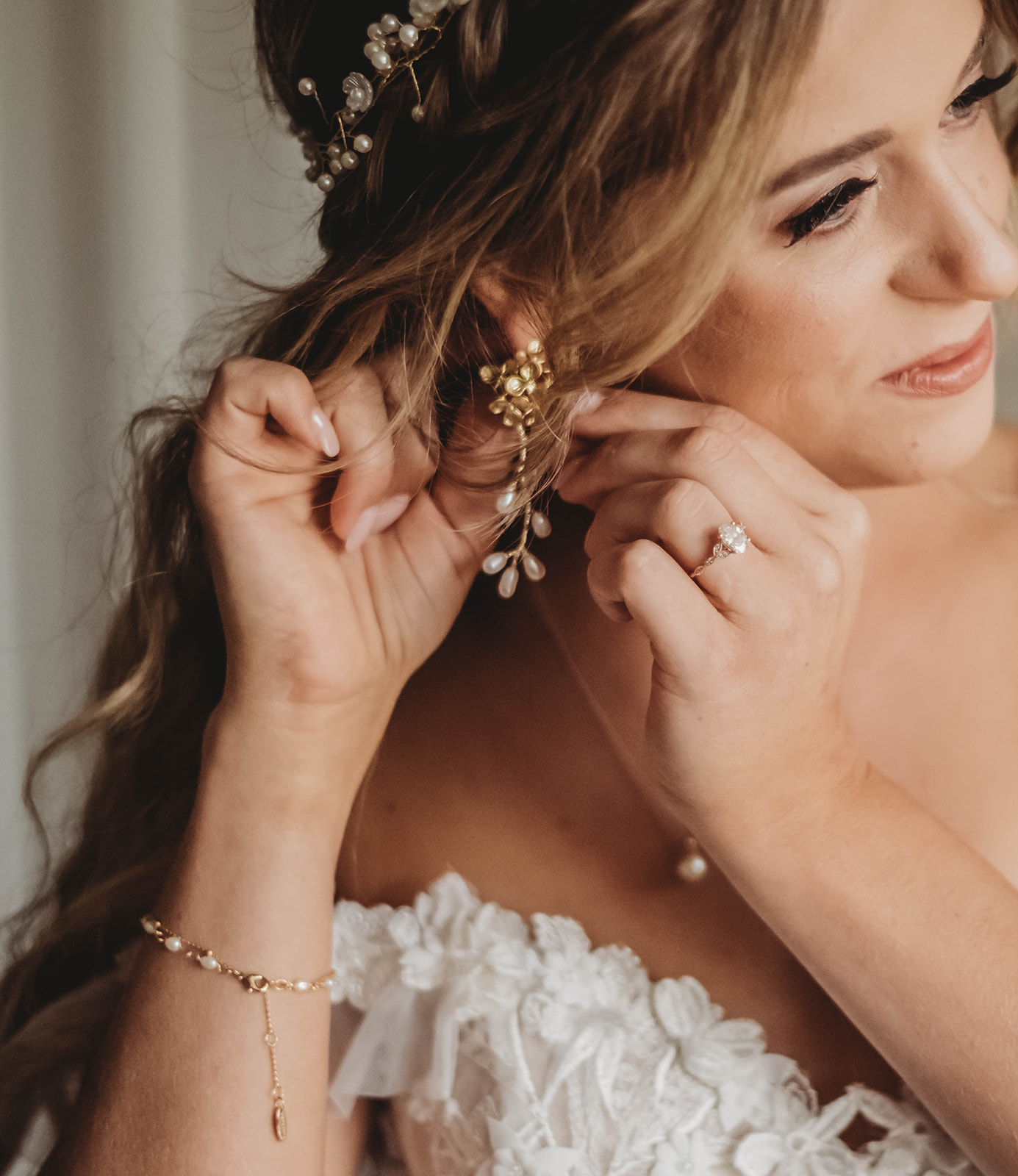 Bride putting on earrings 
