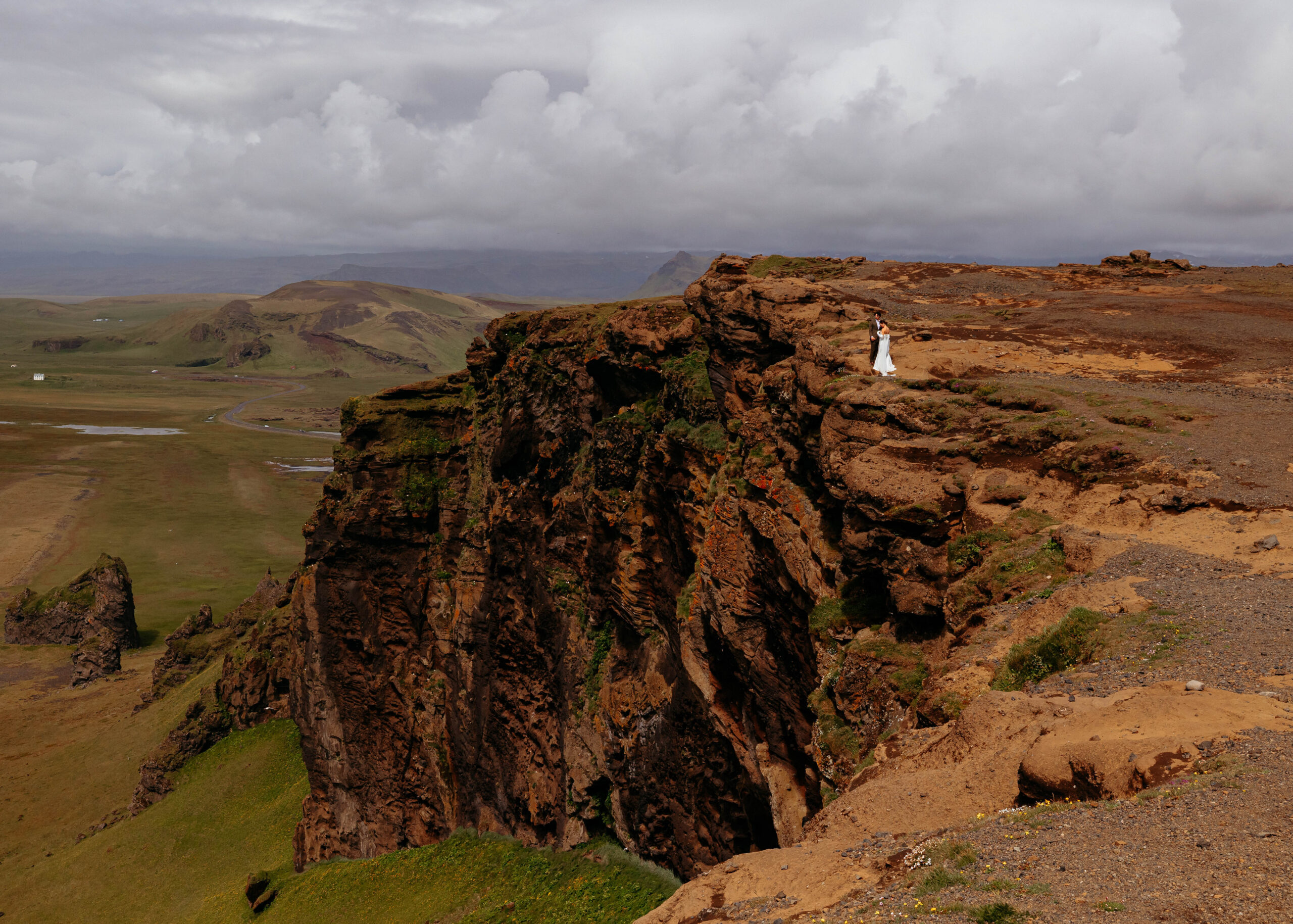 Bride and groom portrait at Dyrhólaey cliffs during Iceland elopement
